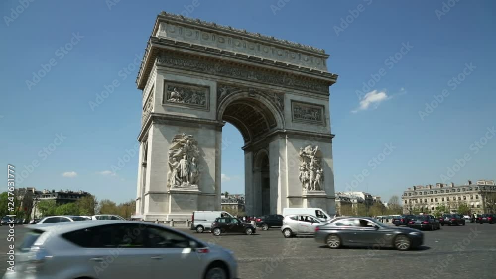 Traffic driving round the Arc de Triomphe in background, Paris, France