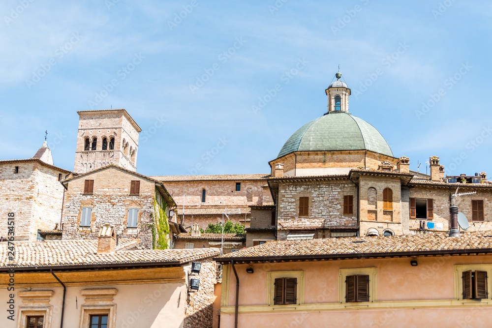 Town or village city of Assisi in Umbria, Italy closeup cityscape view of New Church during sunny summer day and roof buildings