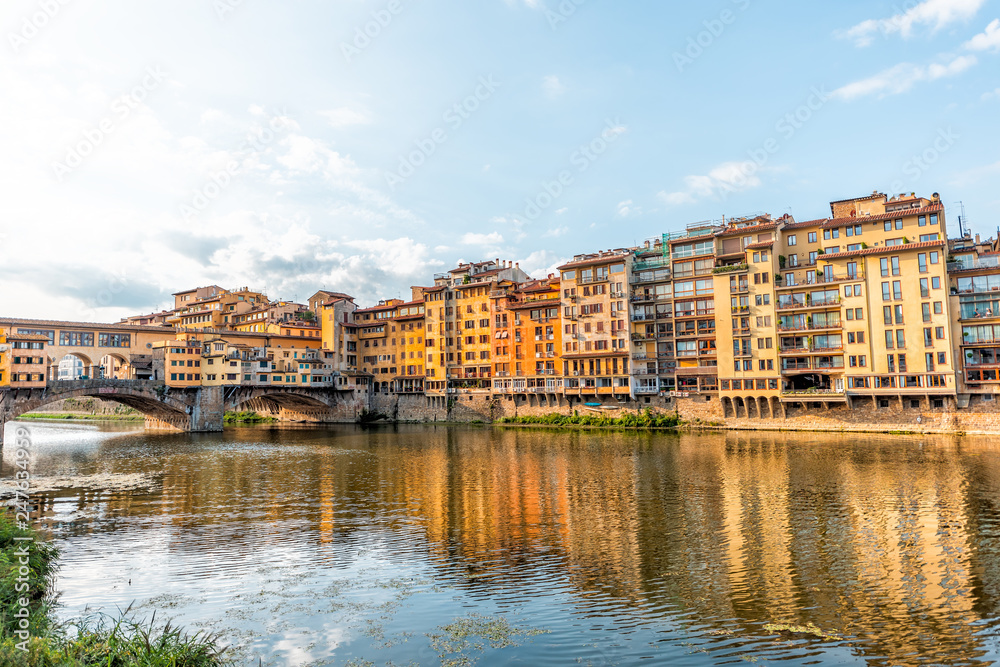 Florence, Italy Firenze orange yellow colorful buildings and Arno river during summer morning sunrise in Tuscany