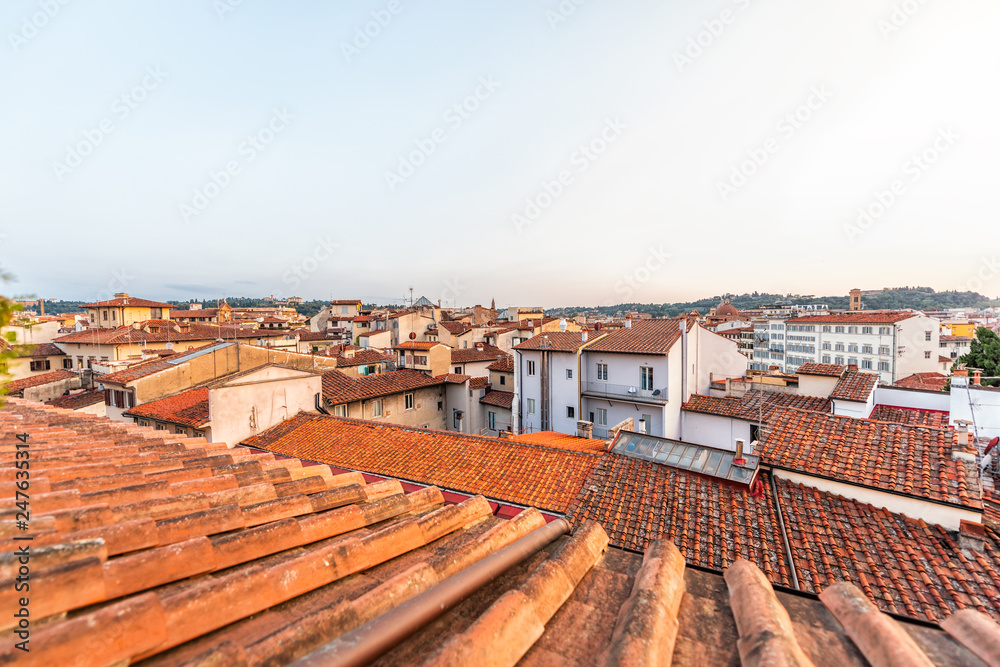 Firenze, Florence, Italy historic city with rooftop tile architecture during summer evening sunset cityscape skyline high angle aerial view of urban roofs
