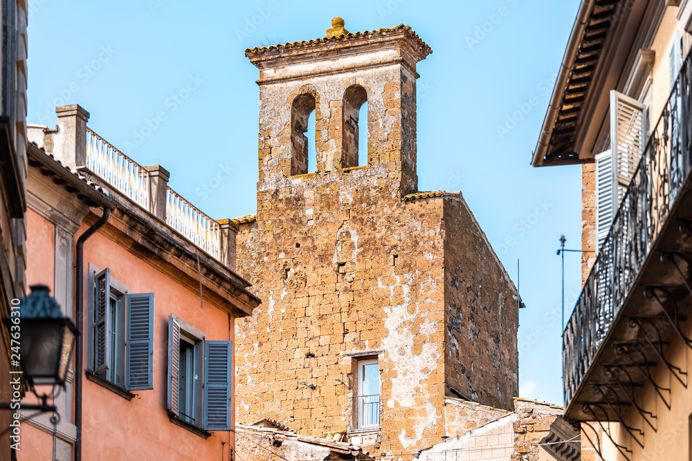 Orvieto, Italy Italian outdoor empty street in Umbria historic city town village road narrow alley with orange walls church bell tower old abandoned ruin closeup Orvieto, Italy Italian outdoor empty street in Umbria historic city town village road narrow alley with orange walls church bell tower old abandoned ruin closeup