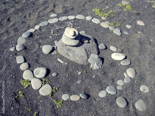 Rock carine on black sand beach of Iceland photo