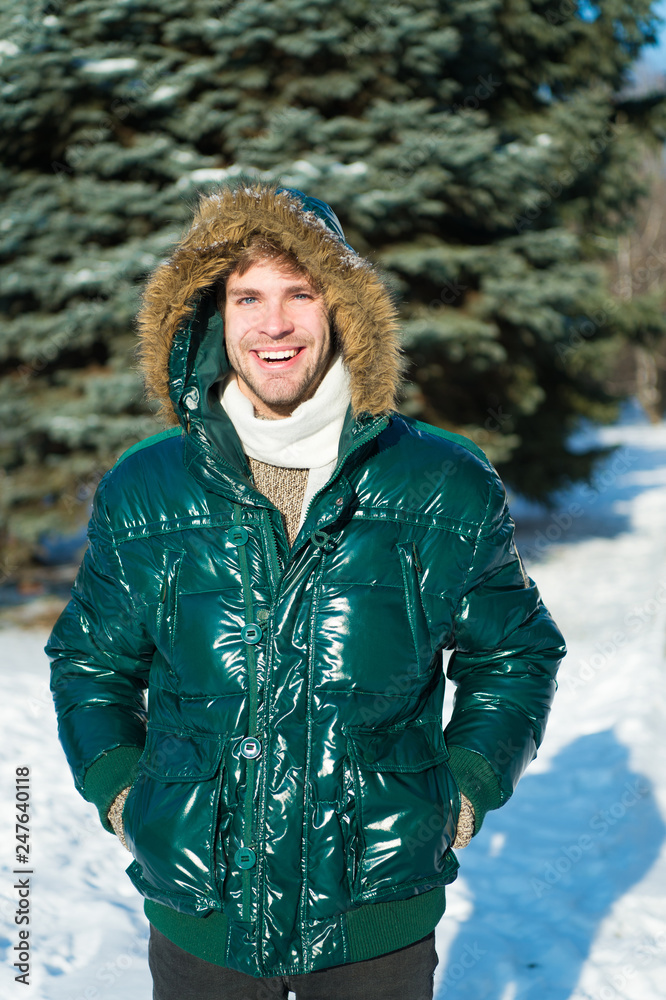 Winter outfit. Man unshaven wear warm jacket with fur snowy nature  background. Guy wear winter jacket with furry hood. Hipster winter fashion.  Prepared for weather changes. Winter stylish menswear Stock Photo