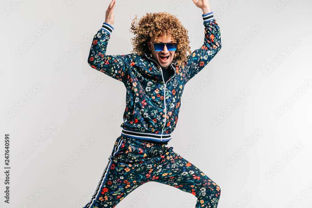 Excited adult funny man in stylish vintage clothes posing on white