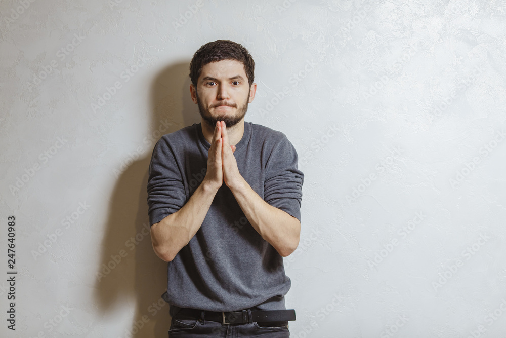 Portrait of man praying, over white textured background. Portrait of man praying, over white textured background.