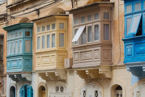 Street with colourful traditional wooden maltese balconies in Sliema, Malta