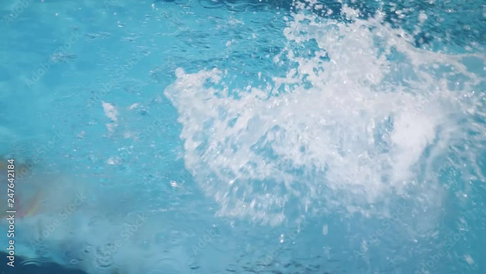Young female professional swimmer jumping in swimming pool slow motion. Young female professional swimmer jumping in swimming pool slow motion.