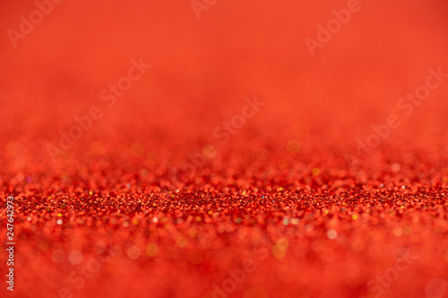 Defocused abstract red glitter texture background