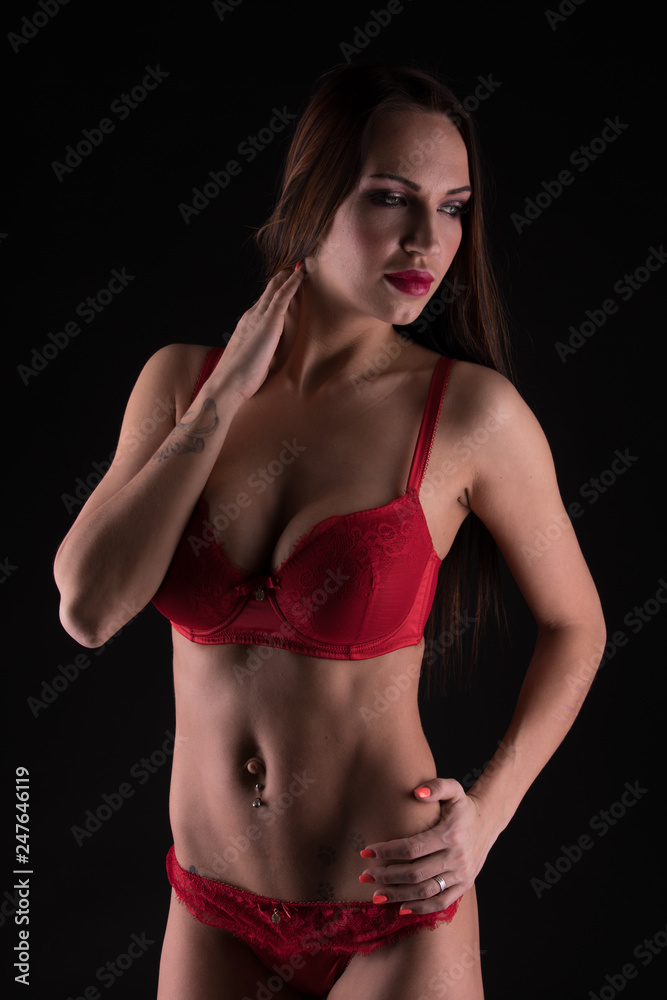 Fototapeta premium Woman in red lingerie in the shadows