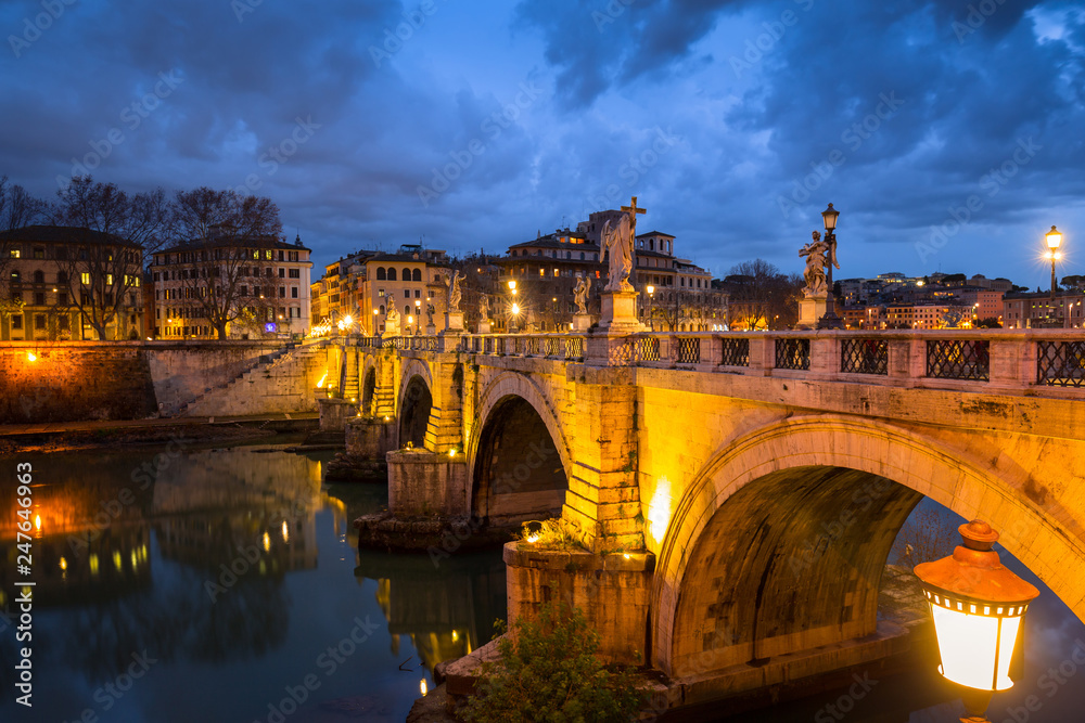 Saint Angel Castle over the Tiber river in Rome at night, Italy