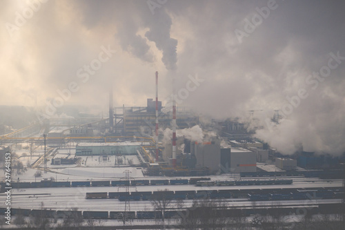 Aerial view of modern combined heat and power plant. Fuming chimney. Heavy industry from above. Power and fuel generation in Poland.