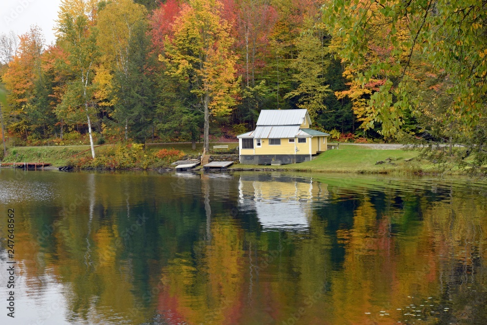 Fototapeta premium Yellow Cottage Reflection On Autumn Pond