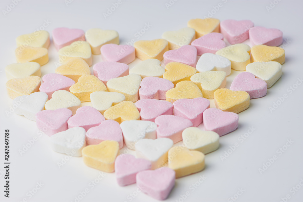 pastel candy hearts in a heart shape on a white background pastel candy hearts in a heart shape on a white background