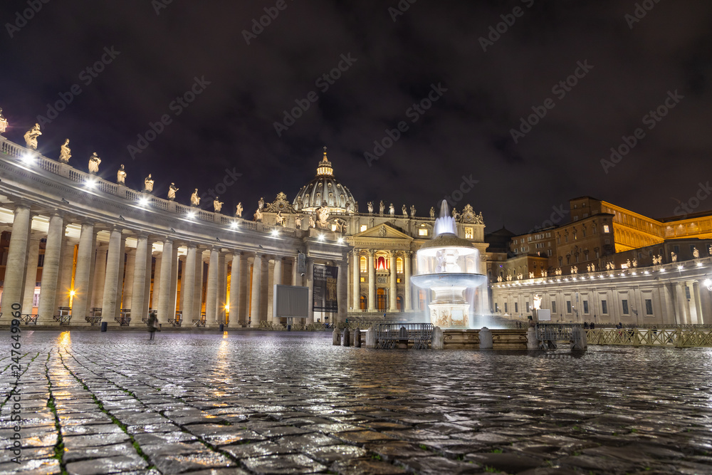 ROME / ITALY - DECEMBER 23, 2018: Night shot of Bernini's fountain and the Basilica at St Peter's piazza in Rome
