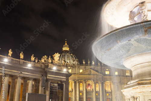 ROME / ITALY - DECEMBER 23, 2018: Night shot of Bernini's fountain and the Basilica at St Peter's piazza in Rome
