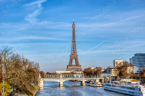 Eiffel tower with Pont Rouelle in foreground and swans island on the left side, on a bright winter afternoon - Paris, France.