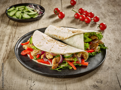 Tortilla wraps with fried chicken meat and vegetables
