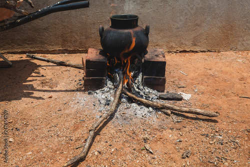 ceramic pot on open wood fire in mexico photo