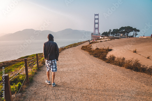 Photography Young man walking near the Golden Gate bridge in San Francisco