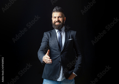 Portrait of smiling businessman shaking hands. Man professional possibly accountant architect businesswoman lawyer attorney. Laughing confident. © Volodymyr