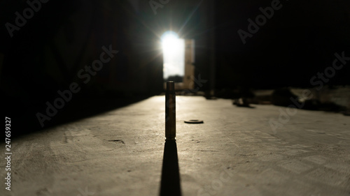 Silueta de una bala con destello del sol photo