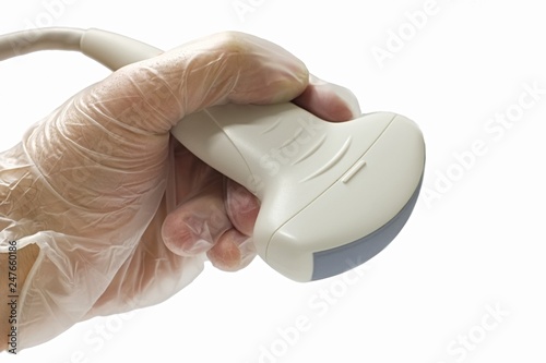 Abdominal convex adult ultrasound probe held in left hand in semi transparent latex glove, white background