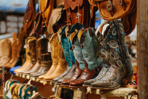 Stylish western boots on a shelf in a store © Rosemarie Mosteller
