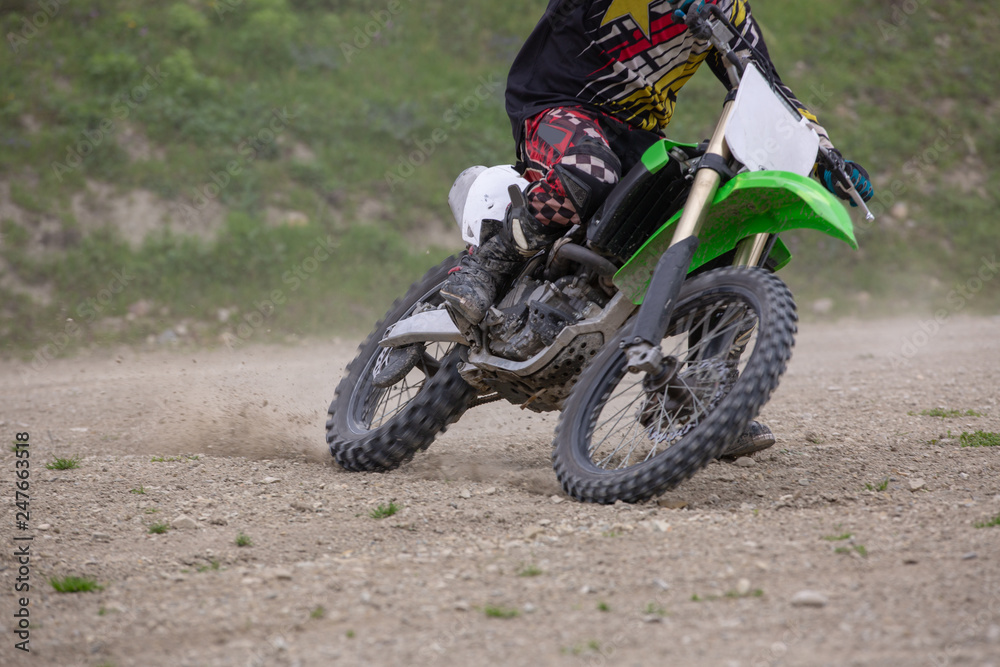 Professional Motocross Motorcycle Rider Drives Over the Road Track.