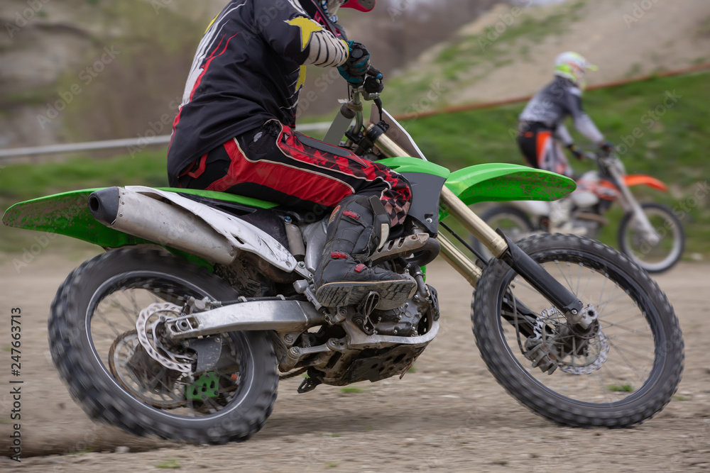 Professional Motocross Motorcycle Rider Drives Over the Road Track.