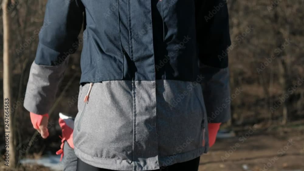 Back view of slim fitness woman working out outdoors in sunny winter Back view of slim fitness woman working out outdoors in sunny winter