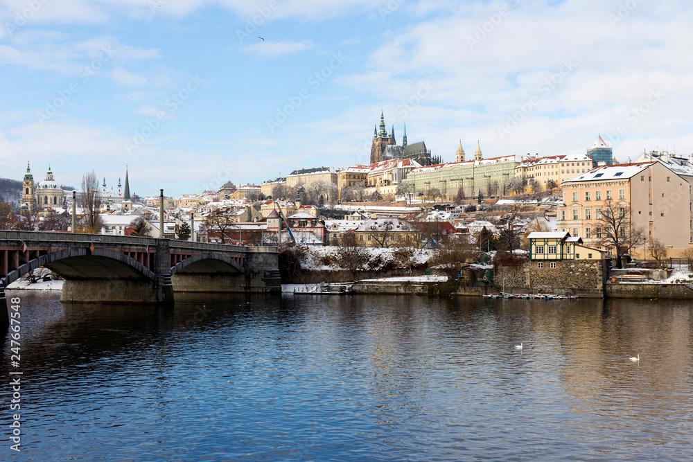 Fototapeta premium Snowy Prague Lesser Town with Prague Castle above River Vltava, Czech republic