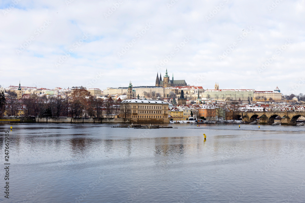 Fototapeta premium Snowy Prague Lesser Town with Prague Castle and Charles Bridge, Czech republic