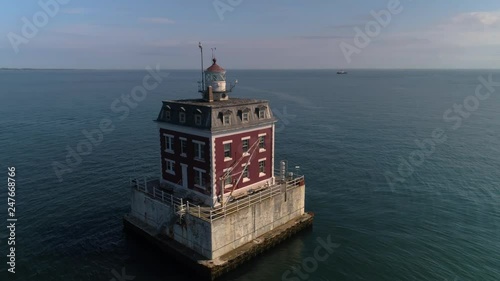 Drone view of a peaceful, isolated lighthouse off the coast of Groton, Connecticut. photo