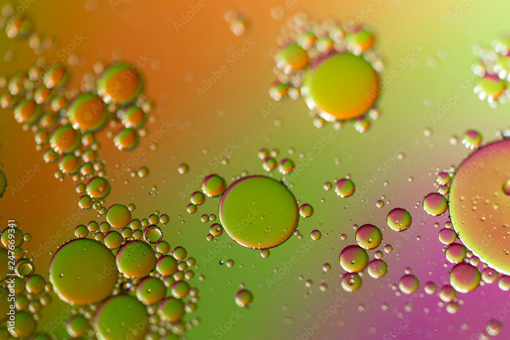 Oil Droplets On Water with Orange Green and Purple Background
