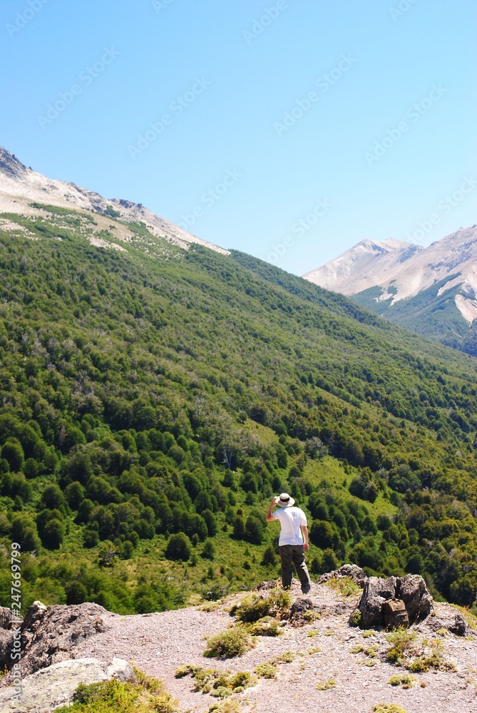 A man walking to a mountain's top / A day hike to a view point of a valley