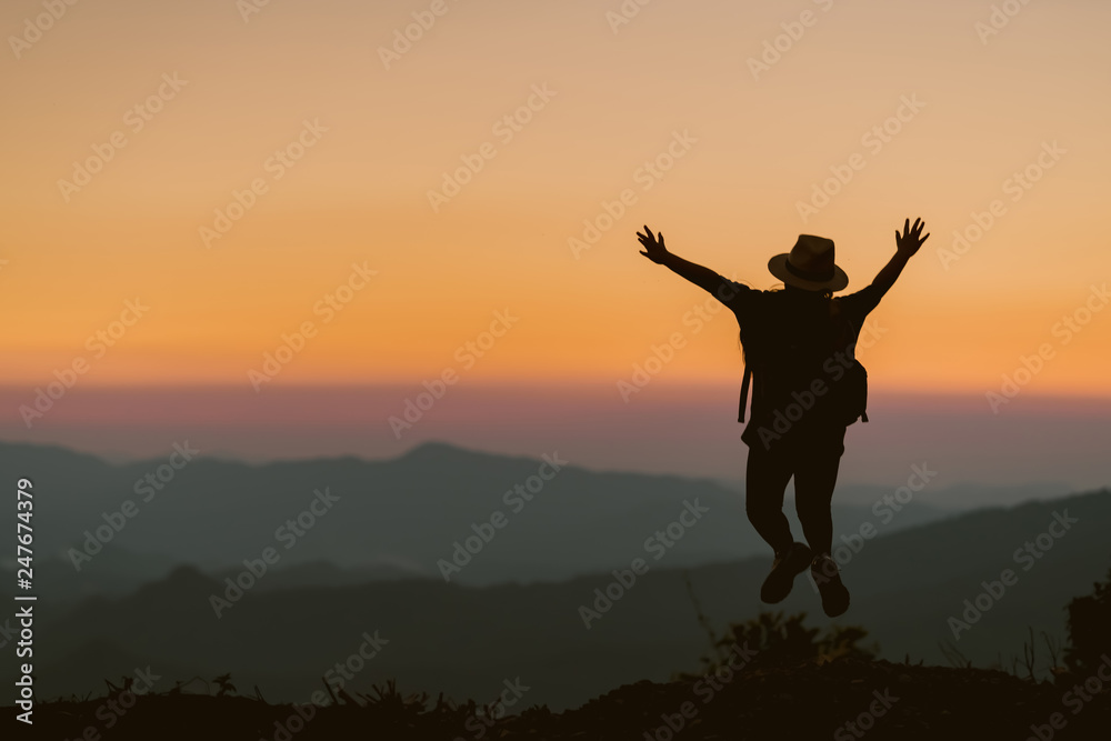 Happy child jump on the background of the sunset in the mountains.