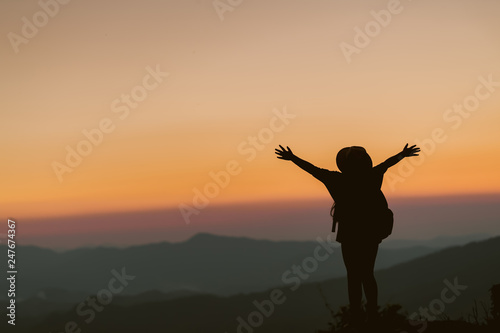 Children are happy to stand and watch the sunset in the mountains. © EKKAPON