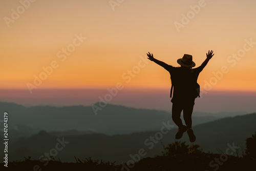 Happy child jump on the background of the sunset in the mountains.