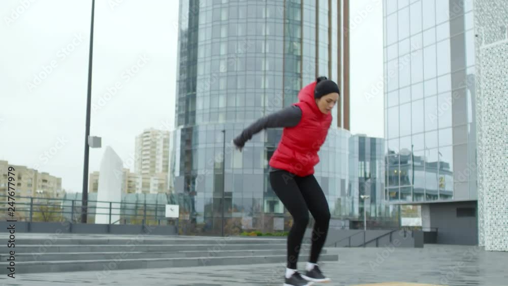 Tilt down shot of athletic young woman jumping on and off bench when working out on city street Tilt down shot of athletic young woman jumping on and off bench when working out on city street