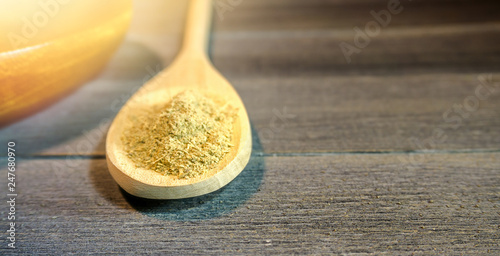 Spoon with Kava Kava root powder in wooden cup
