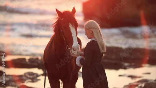 Princess in a vintage dress walking with a horse. blonde girl with back without a face. Background fantastic, fairytale sea at sunset