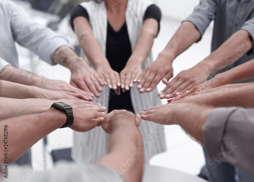 close up.young business team forming a circle of hands
