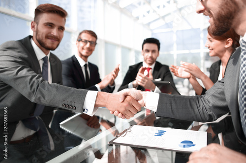 handshake business partners over the Desk