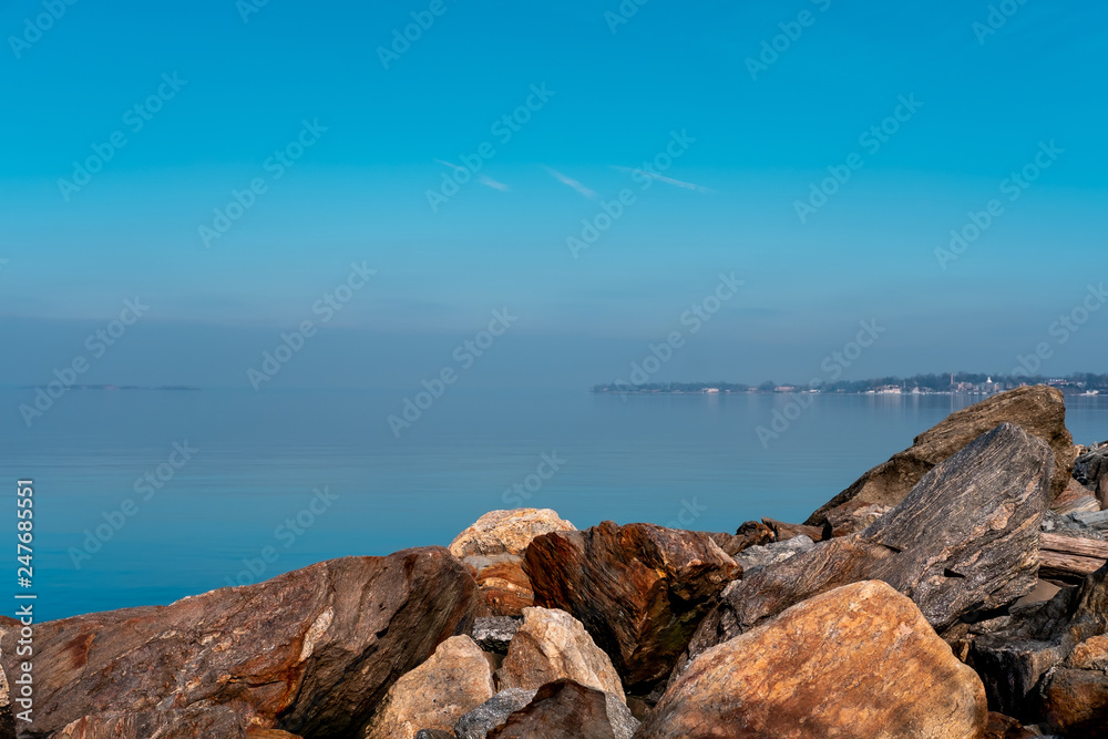 Rocks and blue water with clear sky