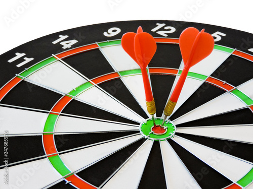 Dart arrow hitting in the target center of dartboard. Success hitting target aim goal achievement concept background.Darts and dart board.Close up shot of the dart arrow.Marketing concept. Dartboard.