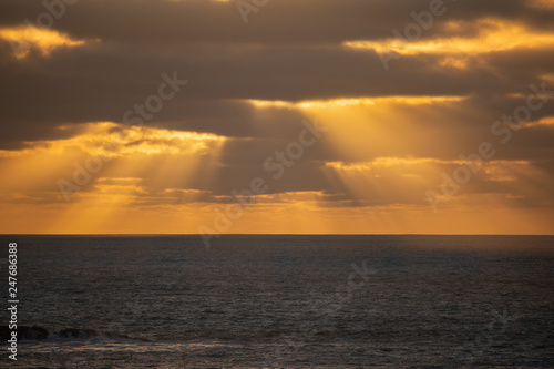 Rays of golden lights at sunset, Muriwai Beach Auckland © Janice