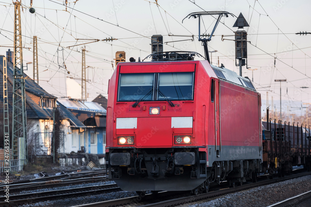 red train on train tracks
