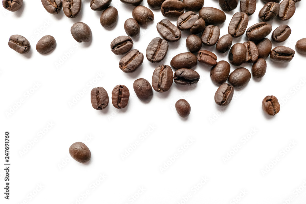 Roasted coffee beans isolated on white background. Close-up.