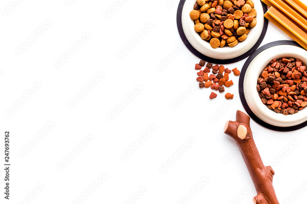 Fototapeta premium Animal food in bowl on white background top view copy space