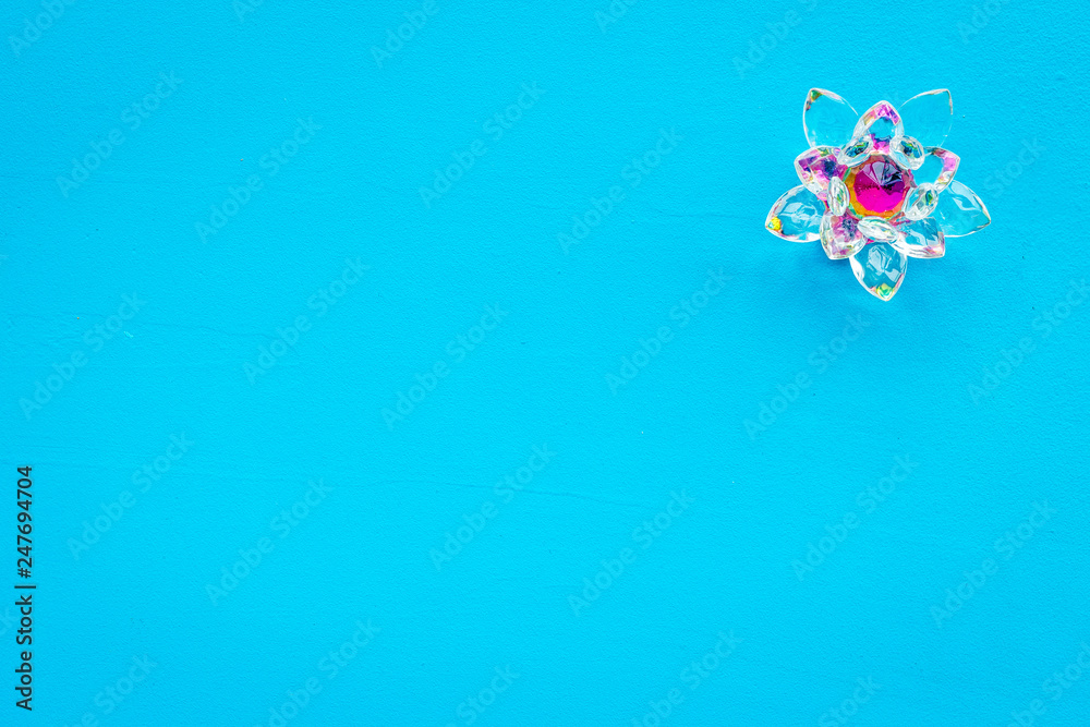 Buddhist symbol. Lotus flower on blue background top view copy space Buddhist symbol. Lotus flower on blue background top view copy space
